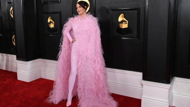 Country pop star Kacey Musgraves stunned in a cotton candy pink jumpsuit and feathered-cape. Picture: Jon Kopaloff/WireImage