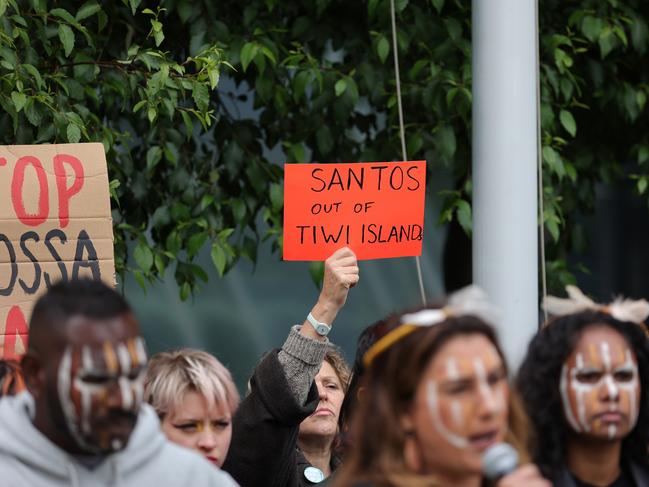 A Protester holds up a sign "Santos Out of Tiwi Islands" at the front of the Federald Court Of Australia on November 15, 2022 in Melbourne, Australia. (Photo by Tamati Smith/Getty Images)