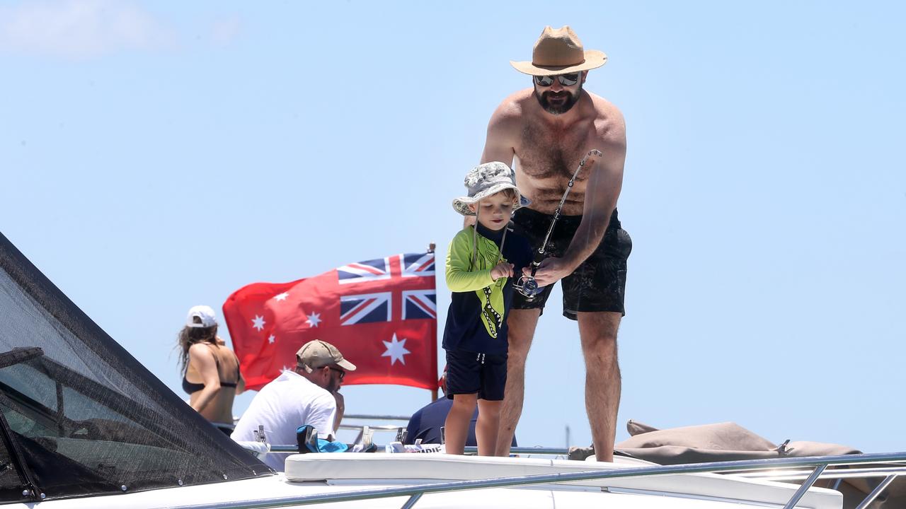 A man and a boy having a fish at Wavebreak Island. Photo by Richard Gosling