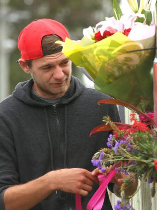 An emotional backpacker with tributes and flowers for Mia Ayliffe-Chung. Picture: Lyndon Mechielsen