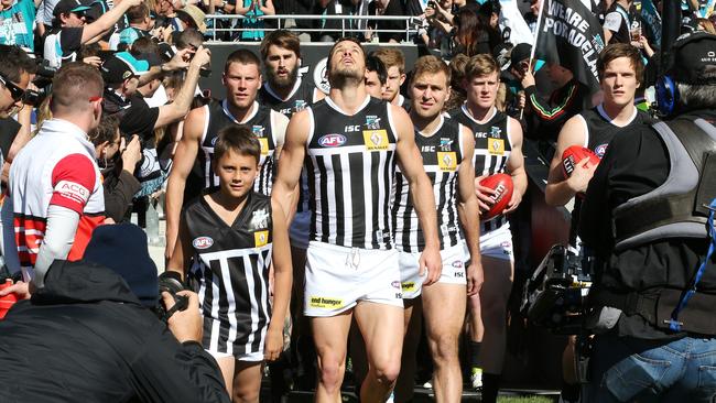 Travis Boak leads his team out onto Adelaide Oval for the 2014 elimination final. Picture: Sarah Reed