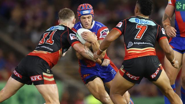 NEWCASTLE, AUSTRALIA - MARCH 13: KalynÃÂ Ponga of the Knights is tackled during the round two NRL match between Newcastle Knights and Dolphins at McDonald Jones Stadium, on March 13, 2025, in Newcastle, Australia. (Photo by Scott Gardiner/Getty Images)