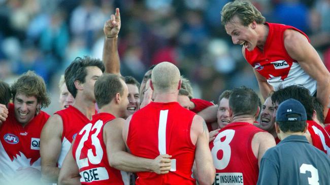 Jude Bolton leaps onto his victorious Sydney teammates.