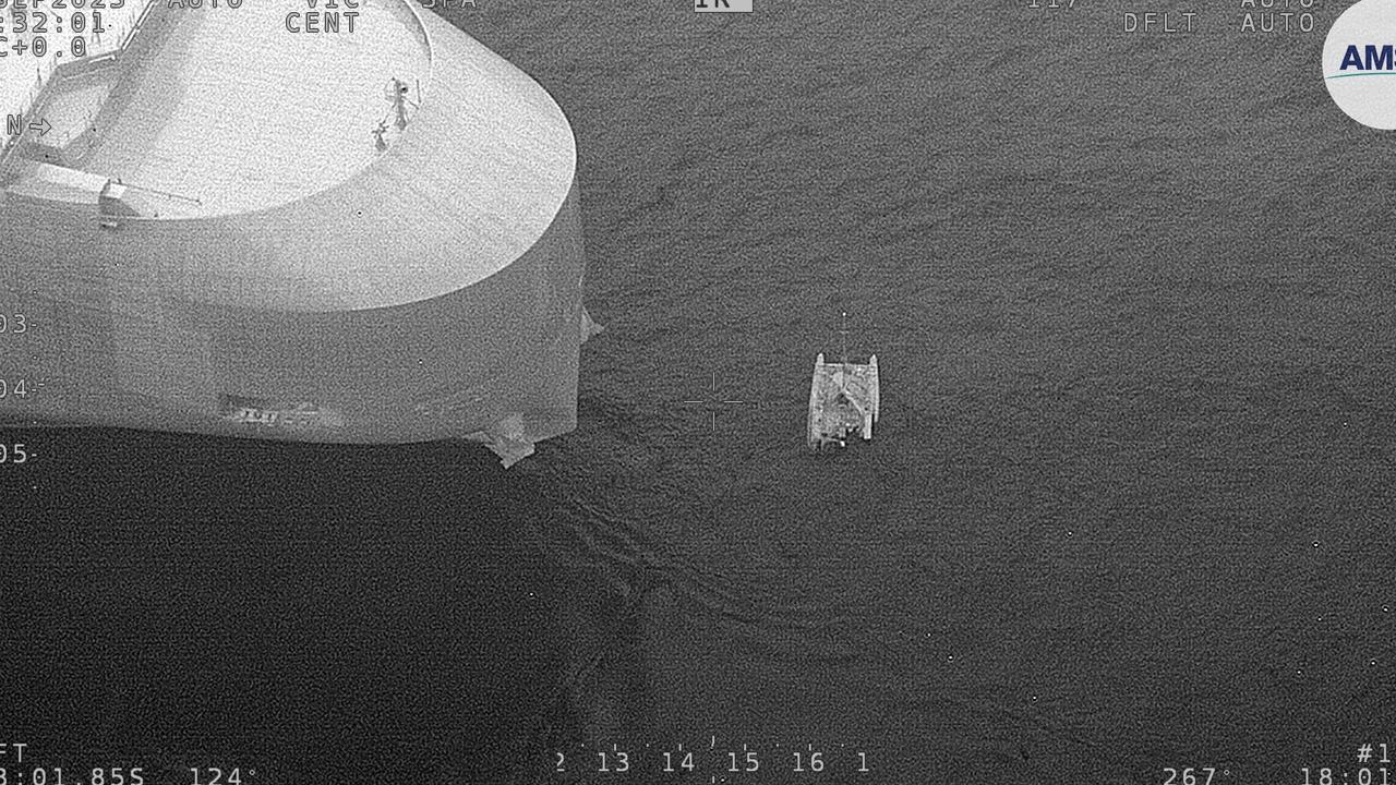 The massive Dugong Ace ship next to the catamaran. Picture: AMSA