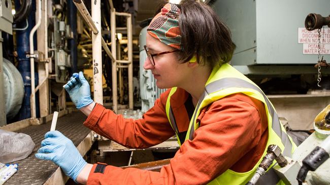 Victoria ‘is turning into the nation’s main defence industry hub’. Dr Jen Wood, of the state’s Swinburne University of Technology, places a corrosion swab in a test tube during the installation of a corrosion prognostic monitoring system on board a frigate, HMAS Parramatta. The project brings together BAE Systems, academics and Defence Science and Technology Group. Picture: Defence Department