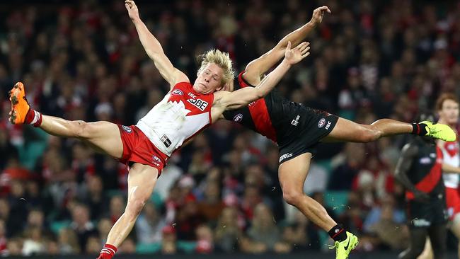 Isaac Heeney of the Swans clashes with Mark Baguley of the Bombers.