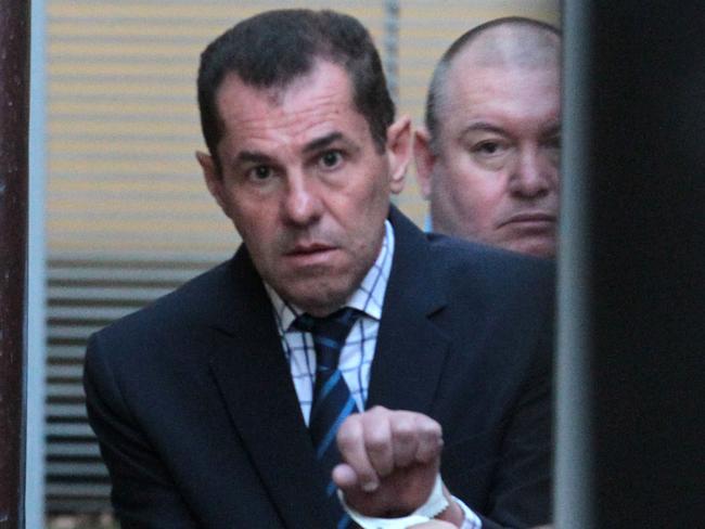 Mark Caleo is led into a prison van after his sentencing hearing in 2018. Picture: AAP