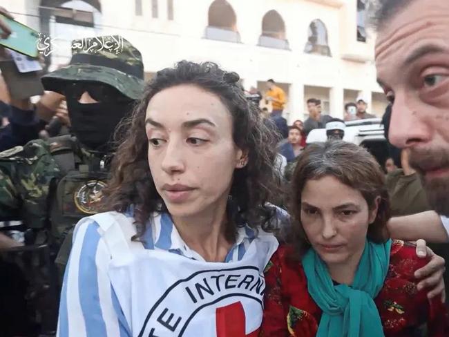 Admit Soussana (in red) who was taken hostage by Hamas during the October 7 attack on Israel is escorted by members of the International Red Cross. Picture: Hamas Military Wing