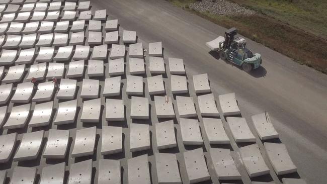 Workers shift concrete panels used to line tunnels as part of the Snowy Hydro 2.0.