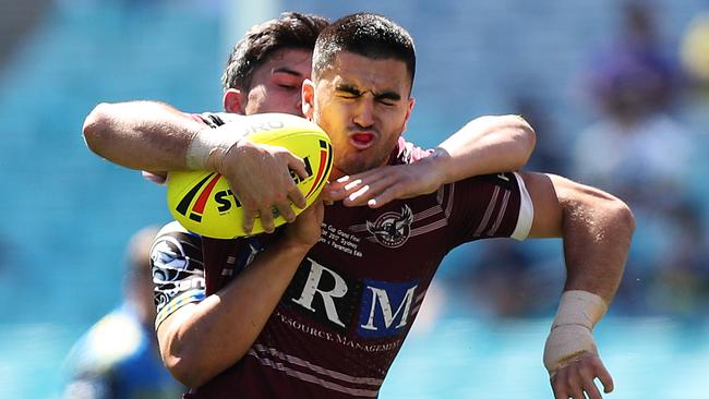 Manly's Tom Wright is tackled by Parramtta's Dylan Brown during the 2017 Holden Cup U20's Grand Final at ANZ Stadium, Sydney. Picture: Brett Costello