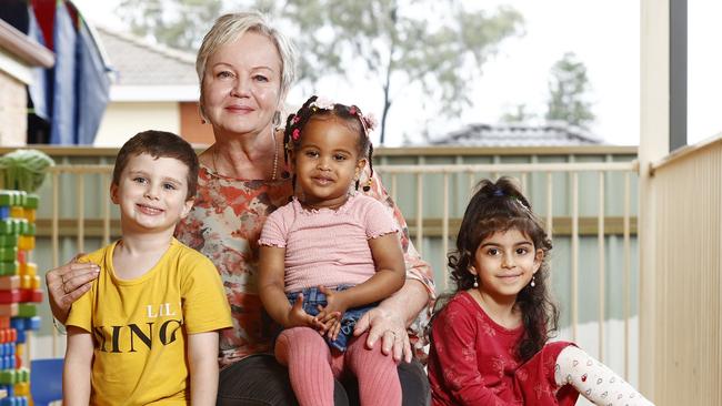 Zuzana Vazan cooks meals for the kids every day, and employs eight people at the centre. Pictured with kids Maximus Karantonis, Aseel Siddig and Merna Said. Picture: Richard Dobson