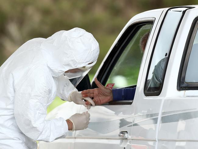 A medical professional administers a drive-through COVID-19 test at the University of California, San Francisco Medical Center. The first test looks for antibodies, the second is a mouth and throat swab that can detect active coronavirus infections. Picture: Getty