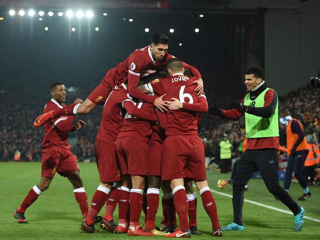 Liverpool's German midfielder Emre Can (L) jumps into the celebration for the third Liverpool goal scored by Liverpool's Senegalese midfielder Sadio Mane.
