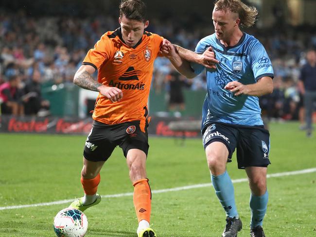 Brisbane Roar’s Scott Neville shields the ball from Sydney FC’s Rhyan Grant. Picture: AAP