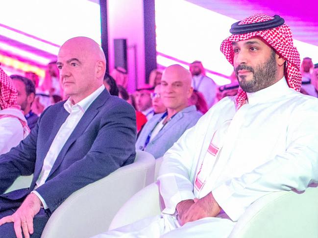 This handout picture provided by the Saudi press Agency (SPA) on October 23, 2023 shows Saudi Crown Prince Mohammed bin Salman MBS (R) and FIFA President Gianni Infantino (C) attending the launch of the Esports World Cup in Riyadh. Saudi Arabia said on October 23 it would organise an eSports World Cup starting next year, the latest boost to a sector Riyadh hopes will create tens of thousands of local jobs. (Photo by SPA / AFP) / === RESTRICTED TO EDITORIAL USE - MANDATORY CREDIT "AFP PHOTO / HO / SPA" - NO MARKETING NO ADVERTISING CAMPAIGNS - DISTRIBUTED AS A SERVICE TO CLIENTS ===