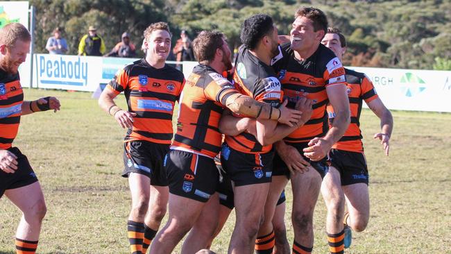 Helensburgh Tigers teammates celebrate with Steve McCallum after he scores a try. Picture: Dorian Cobb