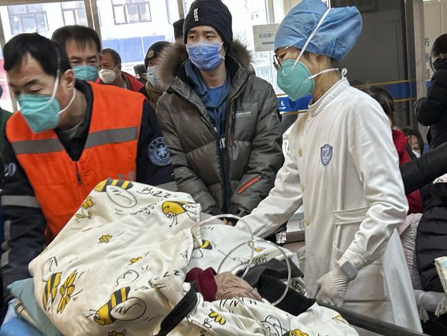 BEIJING, CHINA - JANUARY 02: (CHINA OUT) A patient on oxygen is wheeled on a gurney into a busy emergency room at a hospital on January 2, 2023 in Beijing, China. China has seen a surge in COVID-19 cases since the government lifted its strict zero tolerance measures to contain the virus earlier this month and hospitals in many cities with severe COVID-19 outbreaks have been overwhelmed by the increase in patients. (Photo by Getty Images)