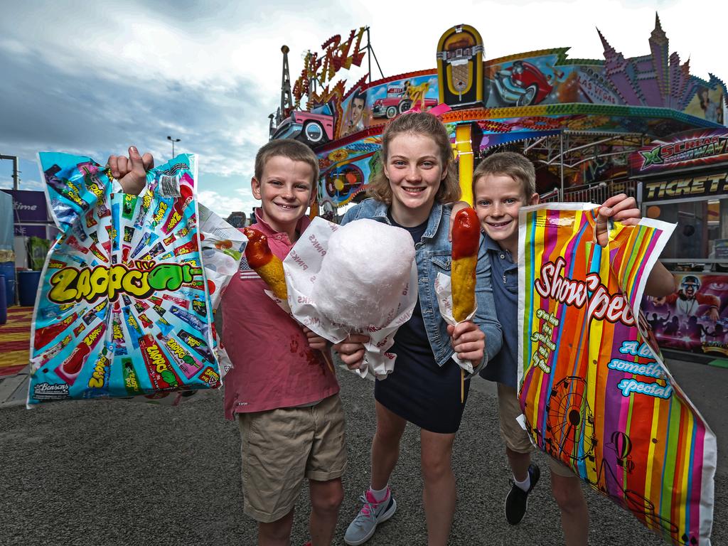 Clem Cook, 11 alongside twin brothers Rupert and Banjo, 9, ahead of the first day of the 2022 Ekka. Picture: Zak Simmonds