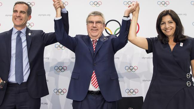 Mayor of Los Angeles Eric Garcetti, IOC President Thomas Bach, and Mayor of Paris Anne Hidalgo celebrate the decision in Lausanne, Switzerland. Picture; AP.