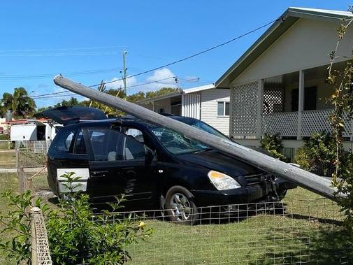 A car has collided with a power line in Bowen, uprooting it from the ground. Photo: Lesley Yasso