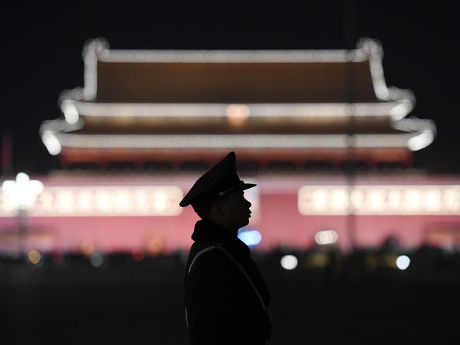 A paramilitary police officer stands guard in Tiananmen Square after Mr Xi secured a path to rule indefinitely. Picture: Greg Baker/AFP