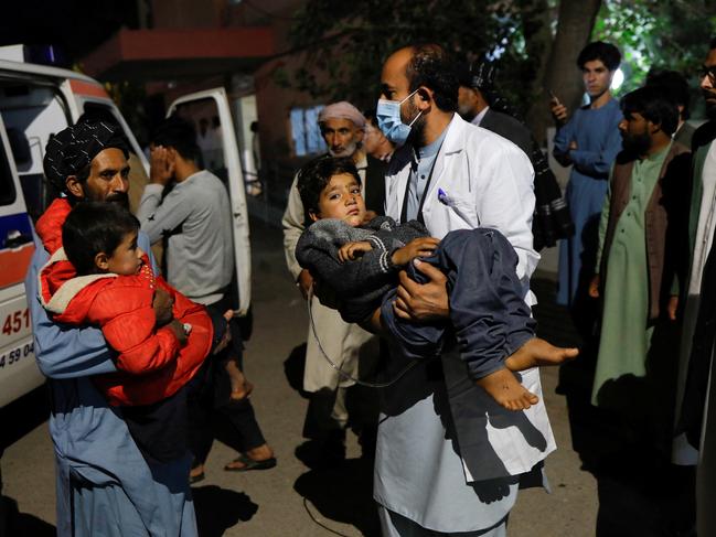 Afghan men carry victims of an earthquake to a hospital in Herat, Afghanistan October 8, 2023. REUTERS/Ali Khara