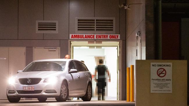 The police officer who shot Kumanjayi Walker wearing a bullet proof vest enters the Alice Springs Hospital after an Royal Flying Doctors Plane landed from Yuendumu. Picture: Emma Murray