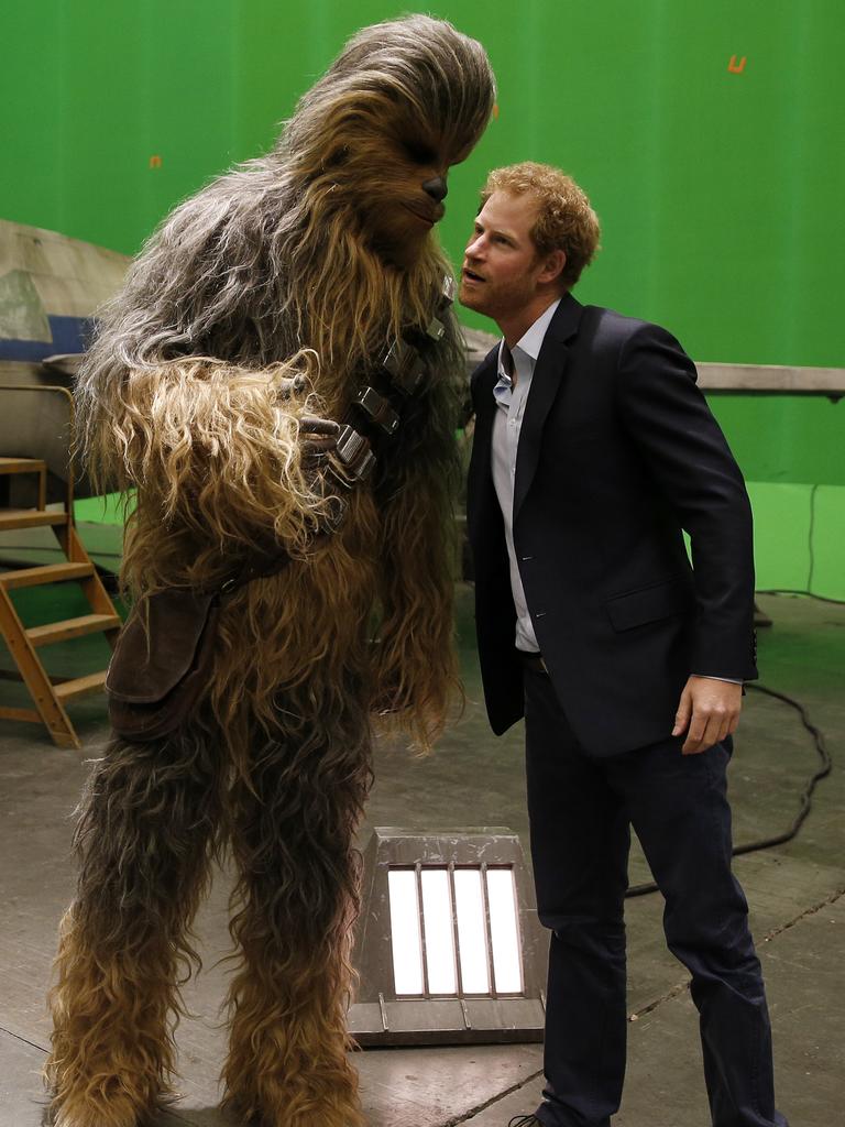 Prince Harry meets the character Chewbacca during a tour of the Star Wars sets at Pinewood studios in Iver Heath, west London, Tuesday April 19, 2016. Picture: AP