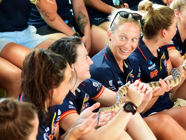 AFLW Adelaide Crows player Marijana Rajcic holds a snake with fellow teammates during a Crow's media event at Crocosaurus Cove in Darwin ahead of their match on Saturday night against Fremantle DockersPicture: Justin Kennedy