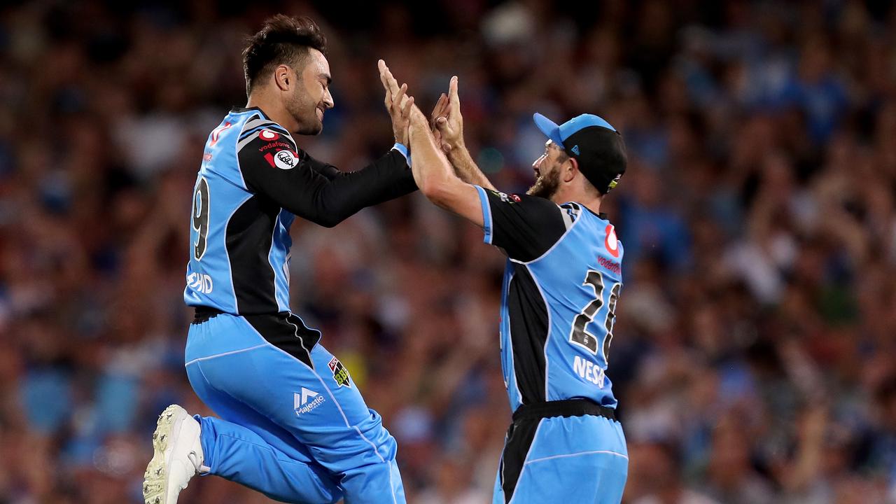 Rashid Khan jumps for joy after snaring a wicket for Adelaide Strikers.