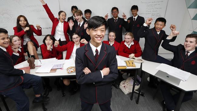 Evan Luc-Tran, 12, is congratulated by his classmates at The McDonald College in North Strathfield after taking out the Prime Minister’s Spelling Bee. Picture: Toby Zerna