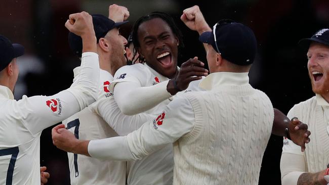 England's Jofra Archer celebrates with teammates after taking the wicket of Australia's Cameron Bancroft. Picture: AFP