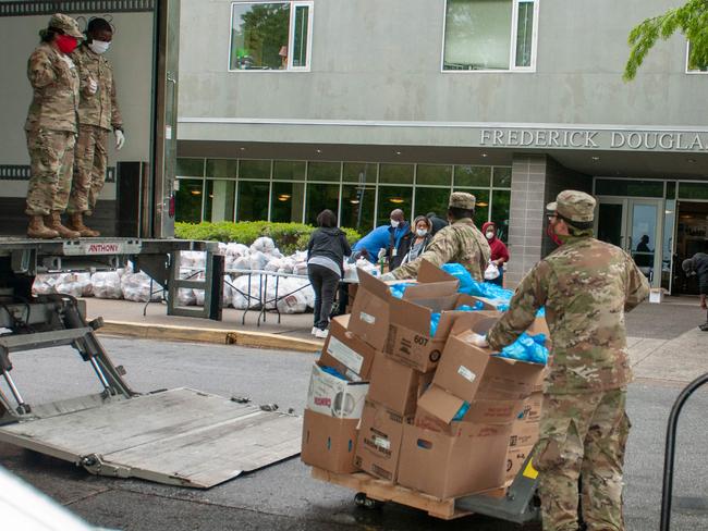 Georgia Army National Guardsmen distribute meals to a school. Picture: AFP