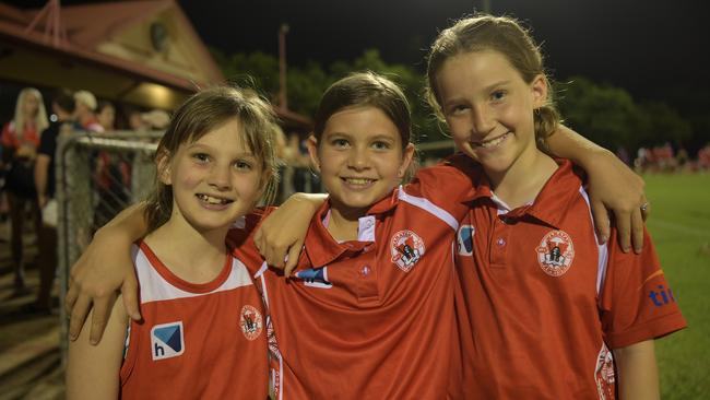 Friends Abby Neal (9), Cleo Rayson (10) and Millie May (9) at the opening game of the NTFL 22/23 season. Picture: (A)manda Parkinson