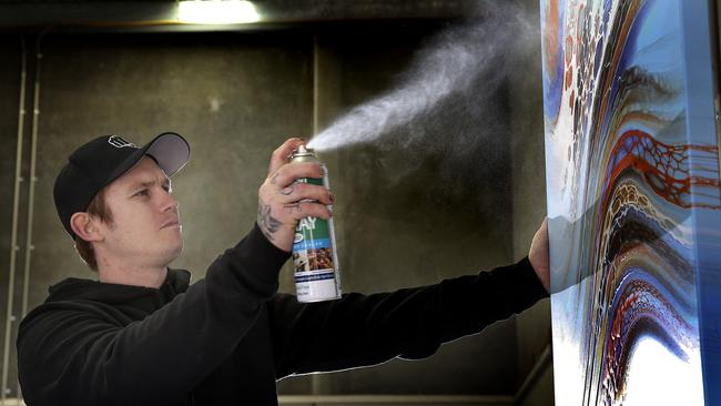 Dayne Beams puts the final touches to art work at his Health of Mind Art studio. Picture: David Caird