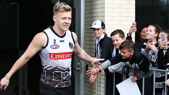 Jordan de Goey of the Magpies is greeted by fans during a Collingwood training session