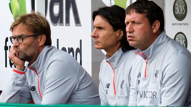 Liverpool's German manager Jurgen Klopp (L) looks on from the dugout.