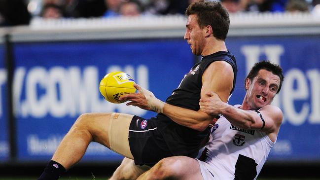 Playing on one of his toughest rivals - Stephen Milne - in 2011. Picture: Colleen Petch