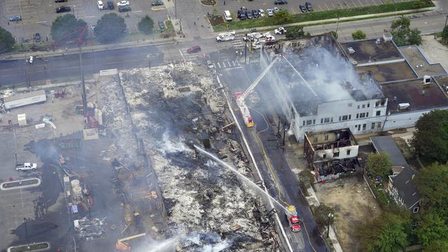 Firefighters work on an apartment building under construction after it was burned to the ground in Minneapolis, during protests. Picture: AP