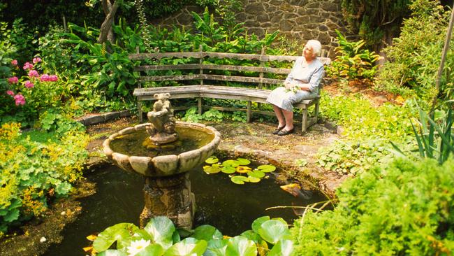 Peace and quiet: The late Dame Elisabeth Murdoch, a keen gardener, enjoying the serenity in her much loved walled garden at Cruden Farm. Designed by Edna Walling, it underwent many changes over the years. Picture: Fawcett Media