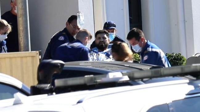 Mahmoud Abbas is led away on a stretcher by paramedics outside his Greenacre home. Picture: TNV