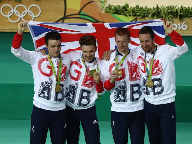 Gold medallists Steven Burke, Owain Doull, Edward Clancy and Bradley Wiggins of Team Great Britain pose for photographs after the medal ceremony for the Men's Team Pursuit. Picture Phil Walter.