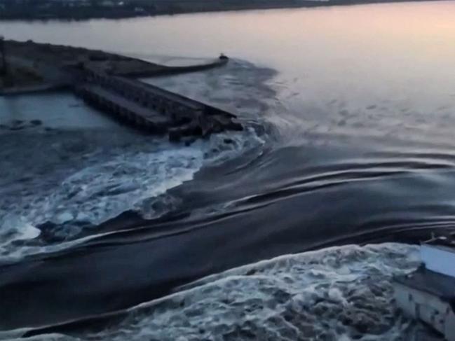 This screen grab from a video posted on Ukraine's President Volodymyr Zelensky's Twitter account shows an aerial view of the dam of the Kakhovka Hydroelectric Power Station after it was partially destroyed. (Photo by various sources / AFP)