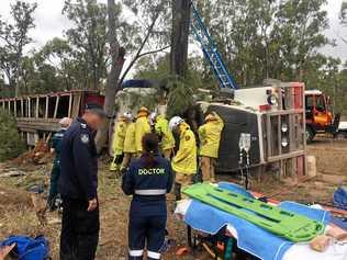 ON SCENE: Crews work to free the trapped driver from his cattle truck. Picture: Contributed