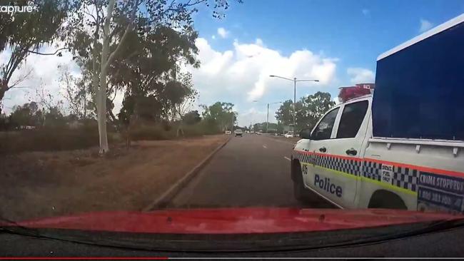 A cop car has narrowly avoided colliding with a Darwin motorist on the Stuart Hwy. Video: Brett Perry