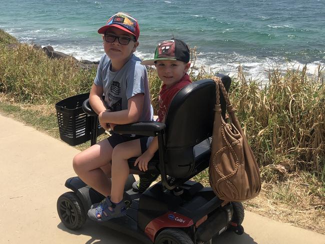 Riley Brown, 9, now requires a wheelchair. With brother Tarek who will also lose his ability to walk.