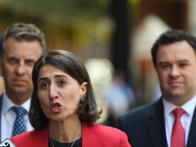 Premier Gladys Berejiklian (centre), NSW Minister for Sport Stuart Ayres (right) and Minister for Transport and Infrastructure, Andrew Constance (left), speak to the media in Sydney, Thursday, March 29, 2018. The New South Wales Government has backed down on its proposal to demolish the Sydney Olympic Stadium, which will instead be refurbished. (AAP Image/Dean Lewins) NO ARCHIVING