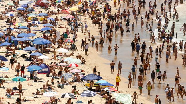 Beachgoers are seen on Bondi Beach in Sydney during Sunday’s scorching temperatures. Picture: AAP Image/Glenn Campbell.