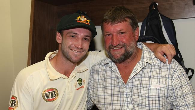 Phil Hughes with father Greg after making his test debut Pic: Hamish Blair