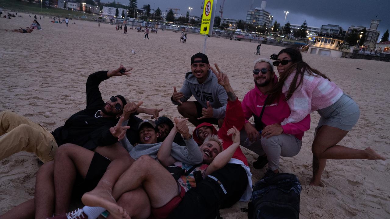 A group of revellers see in the new year by watching the first sunrise come over the horizon. Picture: NCA NewsWire / Mario Francisco